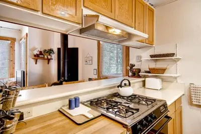 a kitchen with a stove top oven in a kitchen at Ski-InandSki-Out Northstar Condo Near Lake Tahoe! in Truckee