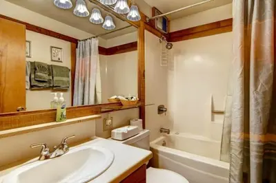 a bathroom with a sink and a toilet and a tub at Ski-InandSki-Out Northstar Condo Near Lake Tahoe! in Truckee