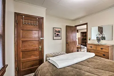 a bedroom with a bed and a wooden door at Lakefront Cabin with Beach Access 8 Mi to Northstar in Tahoe Vista