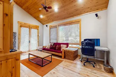a living room with a couch and a tv at Extraordinary Tahoe-Donner Modern Mountain Home in Truckee