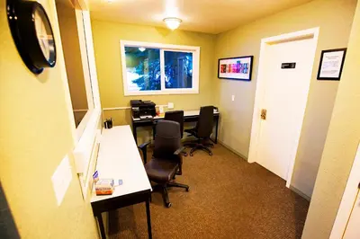 an office with a desk and chairs and a window at The Mammoth House in Mammoth Lakes