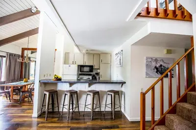a kitchen with a counter and bar stools at The Mammoth House in Mammoth Lakes