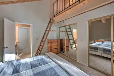 a bedroom with a bunk bed and a mirror at Stateline Ski House Walk to Boulder Lift! in Stateline