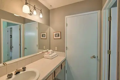 a bathroom with a sink and a mirror and a shower at Stateline Ski House Walk to Boulder Lift! in Stateline