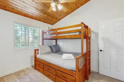 a bedroom with a bunk bed and a ceiling fan at Skyline Serenity in South Lake Tahoe