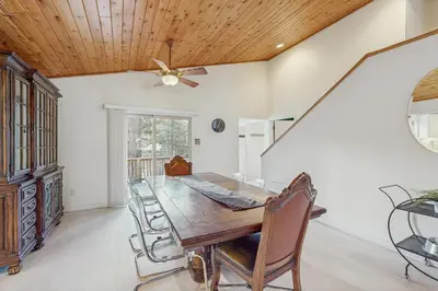 a dining room with a table and a ceiling fan at Skyline Serenity in South Lake Tahoe