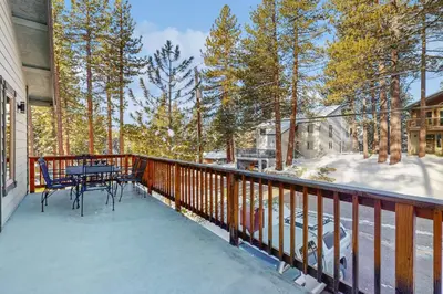 a balcony with a table and chairs on it at Skyline Serenity in South Lake Tahoe