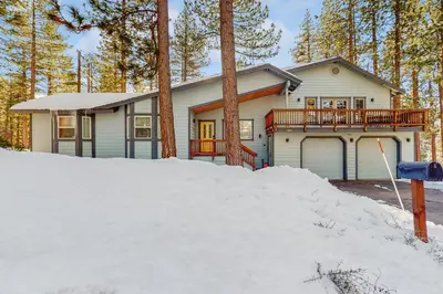 a house with a deck in the snow at Skyline Serenity in South Lake Tahoe