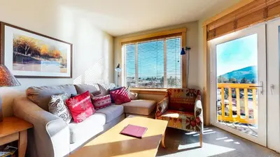 a living room with a couch and a table at Sunstone #209 condo in Mammoth Lakes