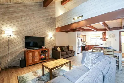 a living room with a couch and a tv at Snowflower #3 condo in Mammoth Lakes