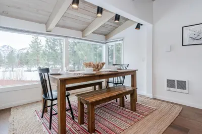 a dining room with a wooden table and chairs at Chateau Blanc 11 in Mammoth Lakes