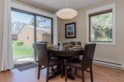 a dining room with a table and chairs and a large window at Snowcreek I 33 in Mammoth Lakes