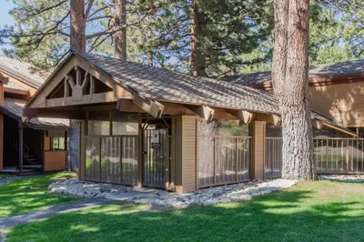 a house with a fence and a tree at Snowcreek I 33 in Mammoth Lakes