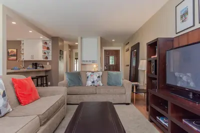 a living room with two couches and a flat screen tv at Snowcreek I 33 in Mammoth Lakes
