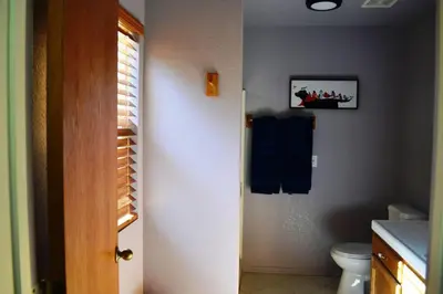 a bathroom with a toilet and a picture on the wall at Blue Jay Paradise in Three Rivers