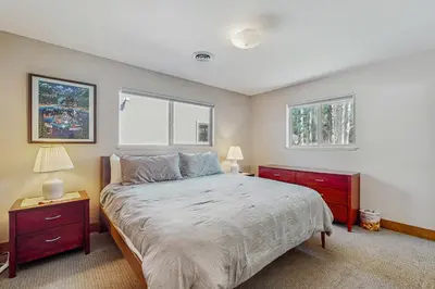 a bedroom with a large bed and two windows at Country Club Retreat in South Lake Tahoe