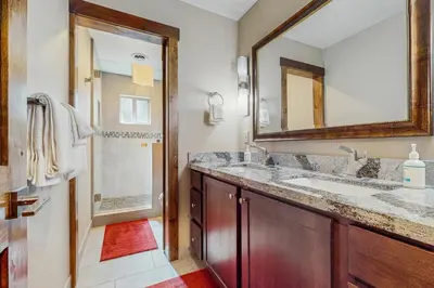 a bathroom with a sink and a mirror and a shower at Country Club Retreat in South Lake Tahoe