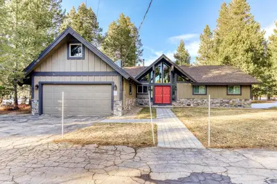 a house with a red door and a driveway at Country Club Retreat in South Lake Tahoe