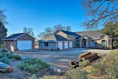 a large house with a garage on a driveway at Hot Tub and Mtn Views Peaceful Columbia Retreat! in Columbia