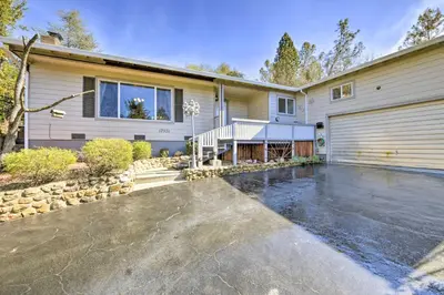 a house with a garage and a driveway at Wine Lovers Garden Oasis in Sutter Creek! in Sutter Creek