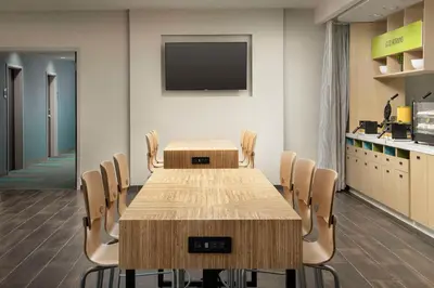 a conference room with a table and chairs at Home2 Suites By Hilton Clovis Fresno Airport in Clovis