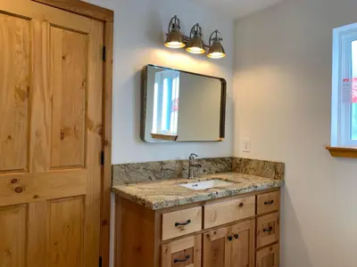 a bathroom with a sink and a mirror at Pioneer in Oakhurst