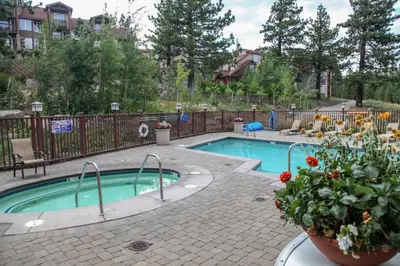 a small swimming pool with flowers in a yard at Sunstone #322 condo in Mammoth Lakes
