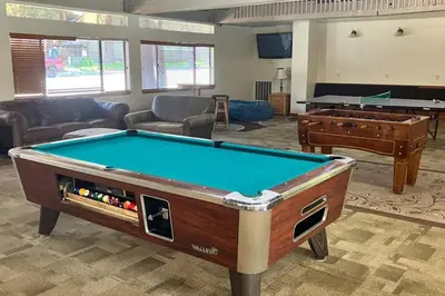 a living room with a pool table and a couch at St. Moritz 13 in Mammoth Lakes