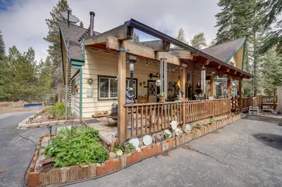 a house with a porch with a fence at Mountain Tops Ponderosa Getaway Near Dome Rock! in Ponderosa