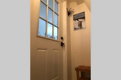a door with a sign on it next to a window at Amazing Loft on Horse Ranch in Pilot Hill