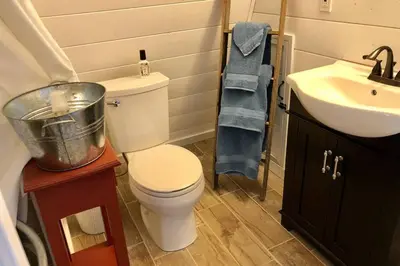a small bathroom with a toilet and a sink at Amazing Loft on Horse Ranch in Pilot Hill