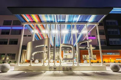 a group of chairs in front of a building at Aloft Reno Tahoe International Airport in Reno