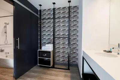 a bathroom with a wall of wine bottles at Aloft Reno Tahoe International Airport in Reno