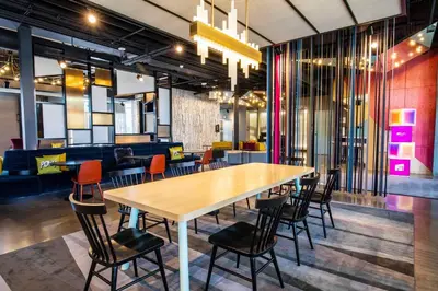 a dining room with a table and chairs at Aloft Reno Tahoe International Airport in Reno