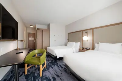 a hotel room with two beds and a desk at Fairfield Inn & Suites by Marriott Lodi in Lodi
