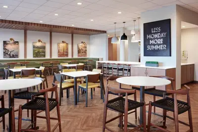 a restaurant with tables and chairs and a bar at Fairfield Inn & Suites by Marriott Lodi in Lodi
