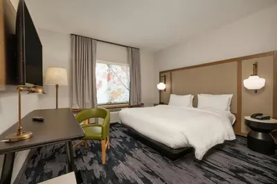 a hotel room with a large bed and a desk at Fairfield Inn & Suites by Marriott Lodi in Lodi