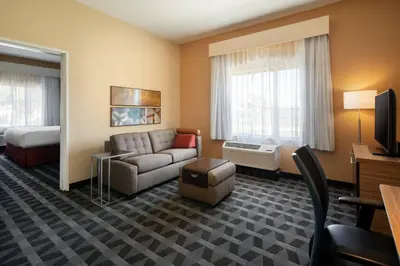 a hotel room with a couch and a bed at TownePlace Suites Fresno Clovis in Clovis