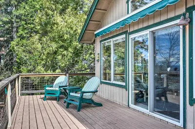 a porch with two chairs and a table on it at Near Hiking Home with Deck in Twain Harte! in Twain Harte