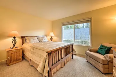 a bedroom with a bed and a window and a couch at Near Hiking Home with Deck in Twain Harte! in Twain Harte