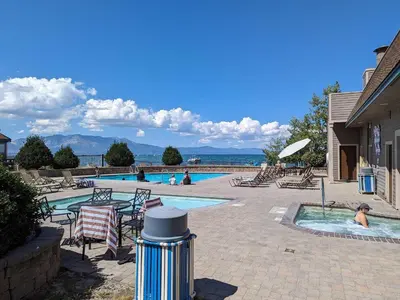 a swimming pool with chairs and people in the water at Lakeland Village #105 in South Lake Tahoe