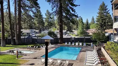 a swimming pool with lounge chairs and a resort at Lakeland Village #105 in South Lake Tahoe