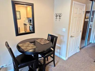 a dining room with a table and a mirror at Lakeland Village #110 in South Lake Tahoe