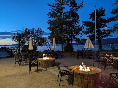 a group of tables and chairs with fires at night at Lakeland Village #110 in South Lake Tahoe
