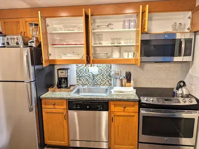 a kitchen with wooden cabinets and stainless steel appliances at Marriott Grand Res Q1 #3256 in South Lake Tahoe