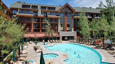 a hotel with a swimming pool and chairs and a building at Marriott Grand Res Q1 #3256 in South Lake Tahoe