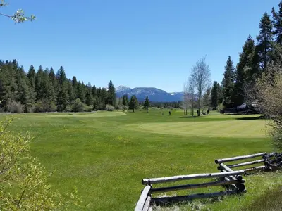 a park with two wooden benches in a field at Marriott Grand Res Q2 #3167 in South Lake Tahoe