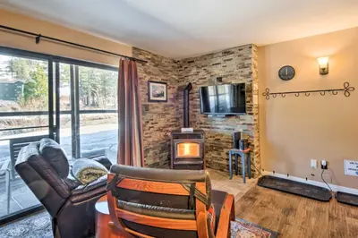 a living room with a couch and a chair and a fireplace at Walk to Ski Lift and Village Lovely Kirkwood Condo! in Kirkwood