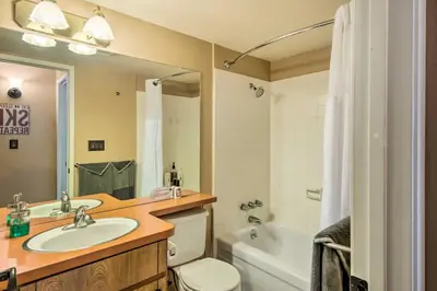 a bathroom with a sink and a toilet and a tub at Walk to Ski Lift and Village Lovely Kirkwood Condo! in Kirkwood