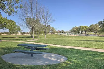 a picnic table in a park with a field at Sacramento Area Apartment 15 Mi to Downtown in Antelope